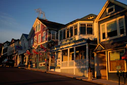 Early-morning light shines on shops in Bar Harbor, Maine, June 11, 2022.