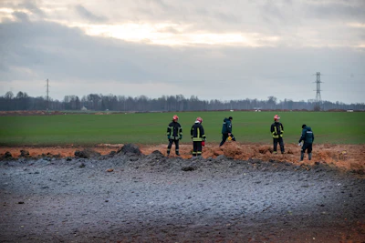 Employees work at the site of the damaged pipeline near Valakeliai village, outside Pasvalys, 175 km (109 miles) north of Vilnius in northern Lithuania on Saturday Jan. 14, 2023.