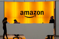 In this Feb. 14, 2019 file photo, people stand in the lobby for Amazon offices in New York. Amazon is ending a charity donation program it ran for a decade in its latest cost-cutting move. In a blog post on Wednesday, Jan. 18, 2023, the company said the program, called AmazonSmile, will shut down by February 20.