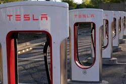 In this April 22, 2021, photo shows a Tesla Supercharger station in Buford, Ga.