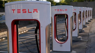 In this April 22, 2021, photo shows a Tesla Supercharger station in Buford, Ga.