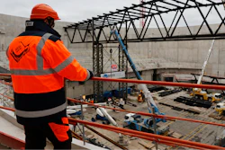A worker looks at the Paris2024 Olympics Porte de la Chapelle Arena building site Monday, Jan. 23, 2023 in Paris.