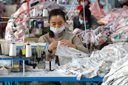 Workers wearing face masks sew fabrics at a textile factory in Huimin county in east China's Shandong province on Oct. 25, 2022. Chinese factory activity rebounded in January from three months of contraction, adding to signs the world’s second-largest economy might be recovering from a painful slump, an official survey showed Tuesday, Jan. 31, 2023.