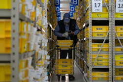 A worker collects parts at SMC, a Japanese pneumatic engineering company factory in Beijing on Jan. 10, 2023. China's trade surplus swelled to a record $877.6 billion in 2022 as exports rose 7% despite weakening U.S. and European demand and anti-virus controls that temporarily shut down Shanghai and other industrial centers.