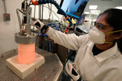Research and development engineer Ravneet Kailey performs an experiment to produce steel without using carbon in a glowing lab cell, left, Wednesday, Jan. 25, 2023, at Boston Metal, in Woburn, Mass.