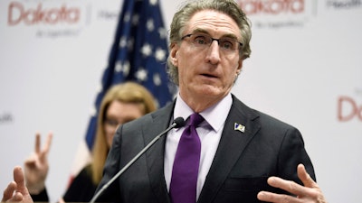 North Dakota Gov. Doug Burgum speaks at the state Capitol in Bismarck, April 10, 2020.