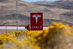In this Oct. 13, 2018, file photo, a sign marks the entrance to the Tesla Gigafactory in Sparks, Nev.