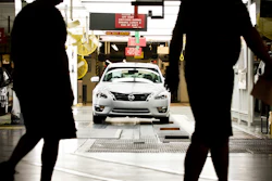 Workers at the Nissan plant in Smyrna, Tenn., walk by a Nissan Altima sedan on May 15, 2012.
