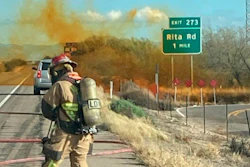In this photo provided by the Tucson Fire Department, personnel work to control the hazardous material leak and brush fire incidents at Rita Rd. and Interstate 10 near Tucson, Ariz., Tuesday, Feb. 14, 2023.