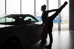A ballet dancer warms up before an open rehearsal at the Audi automobile factory in Gyor, Hungary, Thursday, Feb 16, 2023.