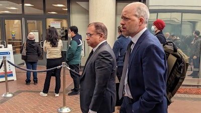 Former Theranos executive Ramesh 'Sunny' Balwani, center, walkes to federal court with his attorney Mark Davies, Friday, Feb. 17, 2023 in San Jose, Calif.