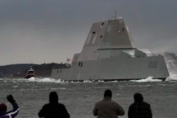 Spectators watch the USS Lyndon B. Johnson Zumwalt-class destroyer travel down the Kennebec River on its way to sea Jan. 12, 2022, in Phippsburg, Maine.