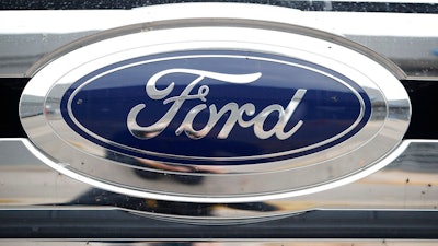 In this Sunday, Oct. 20, 2019, photograph, the company logo shines off the grille of an unsold 2019 F-250 pickup truck at a Ford dealership in Littleton, Colo. Ford reports financial earnings on Thursday, Feb. 2, 2023.