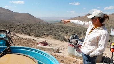 Melissa Boerst, a Lithium Nevada Corp. geologist, points to an area of future exploration from a drill site at the Thacker Pass Project in Humboldt County, Nev., on Sept. 13, 2018. A federal judge on Monday, Feb. 6, 2023, ordered the government to revisit part of its environmental review of a lithium mine planned in Nevada but denied opponents' effort to block the project in a ruling the developer says clears the way for construction at the largest known U.S. lithium deposit.