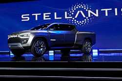 The Ram 1500 Revolution electric battery powered pickup truck is displayed on stage during the Stellantis keynote at the CES tech show on Jan. 5, 2023, in Las Vegas. Automaker Stellantis has reported its earnings grew in 2022 from a year earlier as it pressed an industrywide strategy to shift into electric vehicles, leading to a jump in sales. The company said Wednesday, Feb. 22, 2023, that net revenue of 179.6 billion euros was up 18% from 2021. It reported net profit of 16.8 billion, up 26% from 2021.