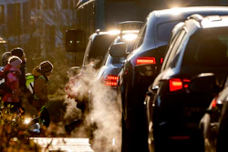 Cars give off exhaust fumes as children head to school in Frankfurt, Germany, on Monday, Feb. 27, 2023. Ever bigger cars pose a growing problem for the environment because they produce more greenhouse gas emissions and need larger batteries than their smaller cousins, according to the International Energy Agency.