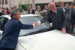 Britain's Trade Secretary Lord Young shakes hands with Shoichiro Toyoda, then president of Toyota Motors, right, over the hood of a Toyota car in London Tuesday, April 18, 1989. Toyoda, who as a son of the company's founder oversaw Toyota's expansion into international markets has died. He was 97.