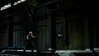 A worker uses cables attached to a crane inside the Zaporizhstal steel plant, in Zaporizhia, Ukraine, Wednesday, March 1, 2023.