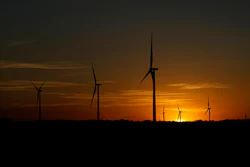 The sun sets behind a wind farm near Del Rio, Texas, Wednesday, Feb. 15, 2023.