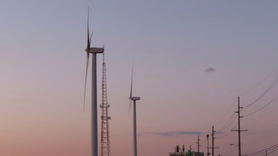 The sun sets behind a land-based wind farm in Atlantic City, N.J. on Feb. 10, 2022.