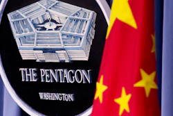 China's national flag is displayed next to the Pentagon logo at the Pentagon, Monday, May 7, 2012.