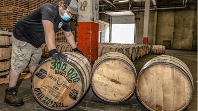 Green River Distilling Co. employee Coleman Savage looks over the 300,000th barrel of bourbon filled at the distillery inside the new-fill warehouse at the plant on April 20, 2021, in Owensboro, Ky.