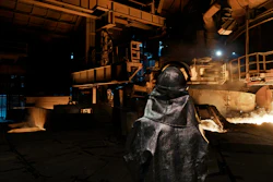A worker stands inside a blast furnace at the Zaporizhstal steel plant, in Zaporizhia, Ukraine, Wednesday, March 1, 2023.