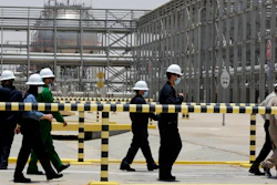 Saudi Aramco engineers escort reporters on a tour of the Hawiyah Natural Gas Liquids Recovery Plant, which is designed to process 4.0 billion standard cubic feet per day of sweet gas, a natural gas that does not contain significant amounts of hydrogen sulfide, in Hawiyah, in the Eastern Province of Saudi Arabia, on June 28, 2021.