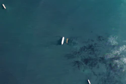 In this satellite photo by Planet Labs PBC, the oil tankers the Oceania, center left, and the Abyss, center right, are seen in the Malacca Strait between Indonesia and Malaysia on Tuesday, March 28, 2023. The Oceania, owned by a major U.S.-traded transportation company, appears to be taking on Iranian crude oil in a key Asian maritime strait in violation of American sanctions, an advocacy group alleges.