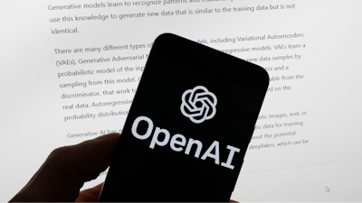 The OpenAI logo is seen on a mobile phone in front of a computer screen displaying output from ChatGPT, Tuesday, March 21, 2023, in Boston.