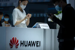 A staff member stands at a booth for Chinese technology firm Huawei at the China International Fair for Trade in Services (CIFTS) in Beijing, Friday, Sept. 3, 2021.