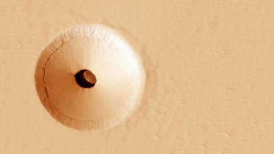 A hole in the surface of Mars, spotted by the HiRISE camera, reveals a cave below. Protected from the harsh surface of Mars, such pits are believed to be good candidates to contain Martian life, making them prime targets for possible future spacecraft, robots and even human interplanetary explorers.