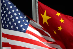 The American and Chinese flags wave at Genting Snow Park ahead of the 2022 Winter Olympics, Feb. 2, 2022, in Zhangjiakou, China. The Biden administration is close to finalizing new regulations that would tighten rules on certain overseas U.S. investment, a move aimed at limiting Beijing’s ability to acquire advanced technologies. That's according to a U.S. official familiar with deliberations who was not authorized to comment.