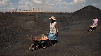 Women push wheelbarrows atop a coal mine dump at the coal-powered Duvha power station, near Emalahleni east of Johannesburg, Nov. 17, 2022. Humanity still has a chance, close to the last one, to prevent the worst of climate change’s future harms, a top United Nations panel of scientists said Monday, March 20, 2023. But doing so requires quickly slashing carbon pollution and fossil fuel use.