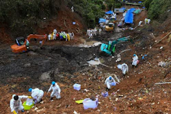 In this photo released by Xinhua News Agency, search and rescuer workers conduct search operations at the China Eastern flight crash site in Tengxian County on March 26, 2022, in southern China's Guangxi Zhuang Autonomous Region.