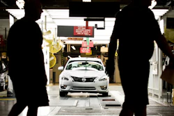 Workers at the Nissan plant in Smyrna, Tenn., walk by a Nissan Altima sedan, May 15, 2012.
