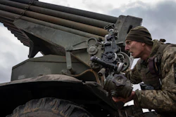 A Ukrainian paratrooper of 95 Air Assault brigade aims to fire by MSLR BM-21 'Grad' towards Russian positions at the frontline near Kreminna, Ukraine, Thursday, March 9, 2023.