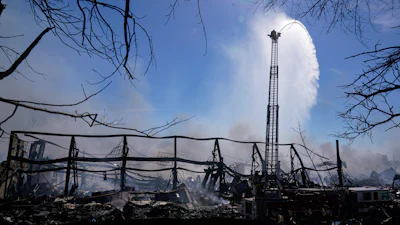 Firefighters pour water on an industrial fire in Richmond, Ind., Thursday, April 13, 2023.