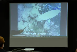 A spokesperson of the Tokyo Electric Power Company Holdings (TEPCO) shows photos captured by a robotic probe inside one of the three melted reactors at the tsunami-wrecked Fukushima nuclear power plant, during a news conference at the TEPCO headquarters in Tokyo, Tuesday, April 4, 2023.