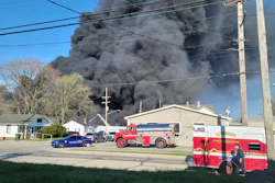 Smoke rises from an industrial fire, Tuesday, April 11, 2023, at 358 NW F Street, in Richmond, Ind.