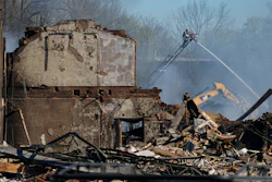 Firefighters pour water on an industrial fire in Richmond, Ind., Thursday, April 13, 2023.