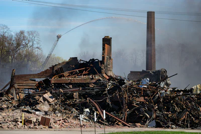 Firefighters pour water on an industrial fire in Richmond, Ind., Thursday, April 13, 2023.