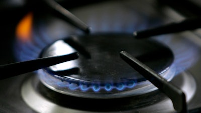 A gas-lit flame burns on a natural gas stove, Jan. 11, 2006.