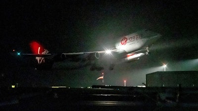A repurposed Virgin Atlantic Boeing 747 aircraft, named Cosmic Girl, carrying Virgin Orbit's LauncherOne rocket, takes off from Spaceport Cornwall at Cornwall Airport, Newquay, England, on Jan. 9, 2023. Virgin Orbit said Thursday March 16, 2023 it is pausing all operations amid reports that the company is furloughing almost all its staff as part of a bid to seek a funding lifeline.