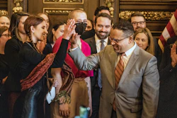 Attorney General Keith Ellison gives a high five to Katy Johnson, who was once addicted to vaping in St. Paul, Minn., on Wednesday, May 17, 2023.