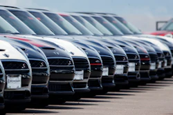 A line of unsold 2018 Cooper Clubmen sit in a long row at a Mini dealership, March 30, 2018, in Highlands Ranch, Colo.