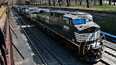 A Norfolk Southern freight train rolls through downtown Pittsburgh, March 26, 2018.