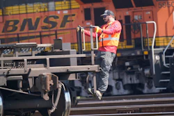 A worker rides a rail car at a BNSF rail crossing in Saginaw, Texas, Wednesday, Sept. 14, 2022. Tens of thousands of engineers remain frustrated with the lack of paid sick time and the demands railroads like BNSF are making in negotiations despite the progress that has been made in 2023 with sick time deals for most of the other rail unions.