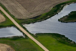 A road bisects a wetland on June 20, 2019, near Kulm, N.D. The Supreme Court has made it harder for the federal government to police water pollution. The decision from the court on Thursday, May 25, 2023, strips protections from wetlands that are isolated from larger bodies of water. It’s the second ruling in as many years in which a conservative majority has narrowed the reach of environmental regulations.