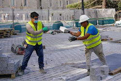 Two men work at a construction site during a heatwave in Madrid, Spain, Friday, Aug. 13, 2021.
